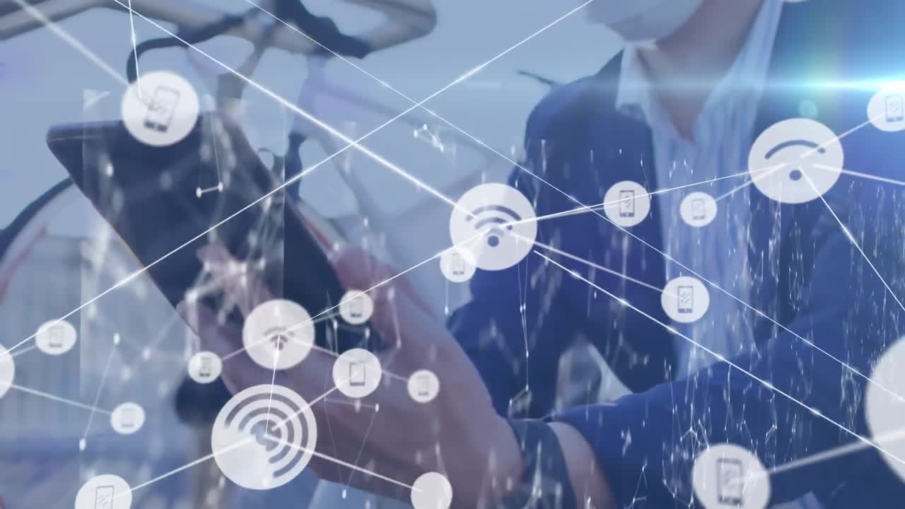 Network of digital icons against asian businessman wearing face mask using digital tablet