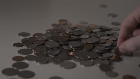 coins being selected out of a large pile