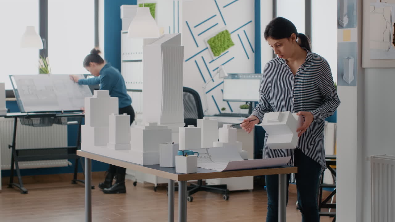 Architects working on architectural models in a design studio
