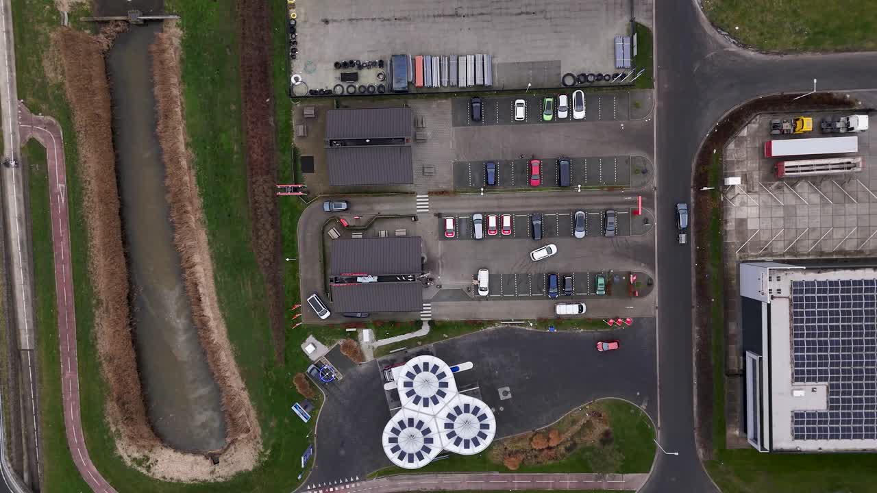 Aerial view of a parking lot with cars and solar panels