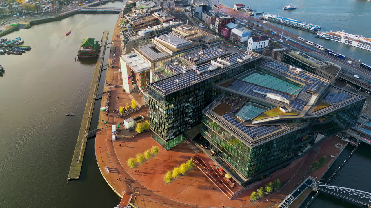 Amsterdam, Netherlands - November 19, 2024: Aerial drone view of the Conservatorium Hotel and surrounding waterfront area in the Oosterdokseiland area