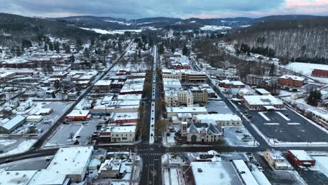 aerial truck shot of wellsboro pa during winter, christmas time snow storm