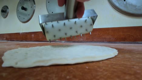 pizza commercial kitchen closeup of rolling dough