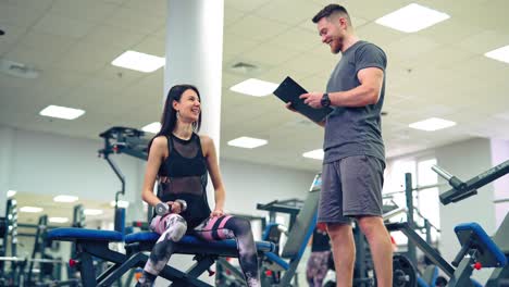 personal trainer working with his client in gym. personal fitness instructor.