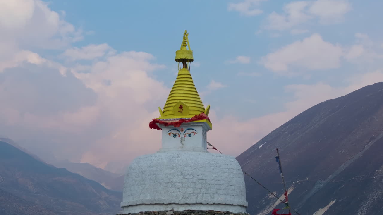 Drone shot of Dingboche Stupa (4400m) with mountain backdrop, cloudy sky, and serene wind – peaceful spiritual moment in Nepal Himalayas nature