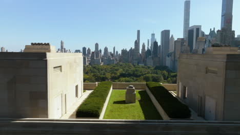 aerial tracking shot of central park, behind a building in lincoln square, in ny