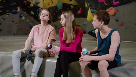 friends resting in a climbing gym