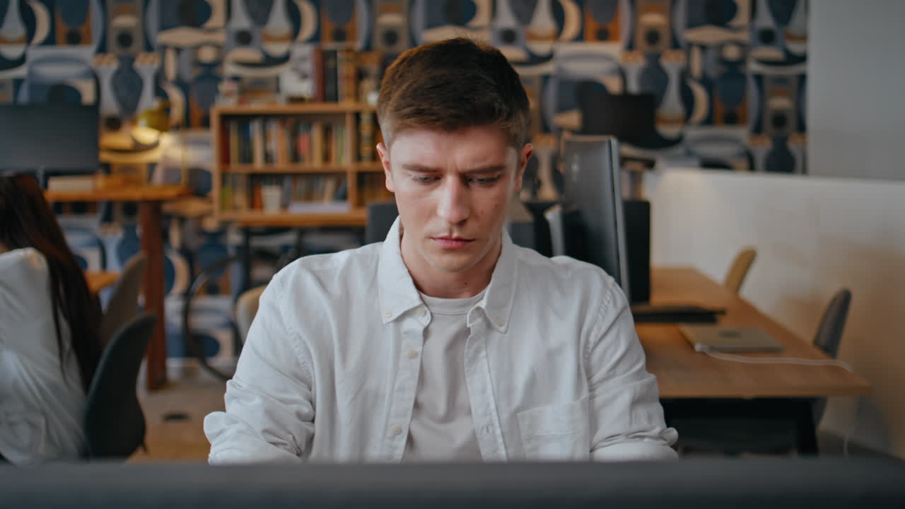 Tired designer stretching hands working computer in office workplace closeup