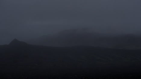 dramatic iceland landscape at night, camera movement, camera pan from left to right to reveal a one person walking into distance