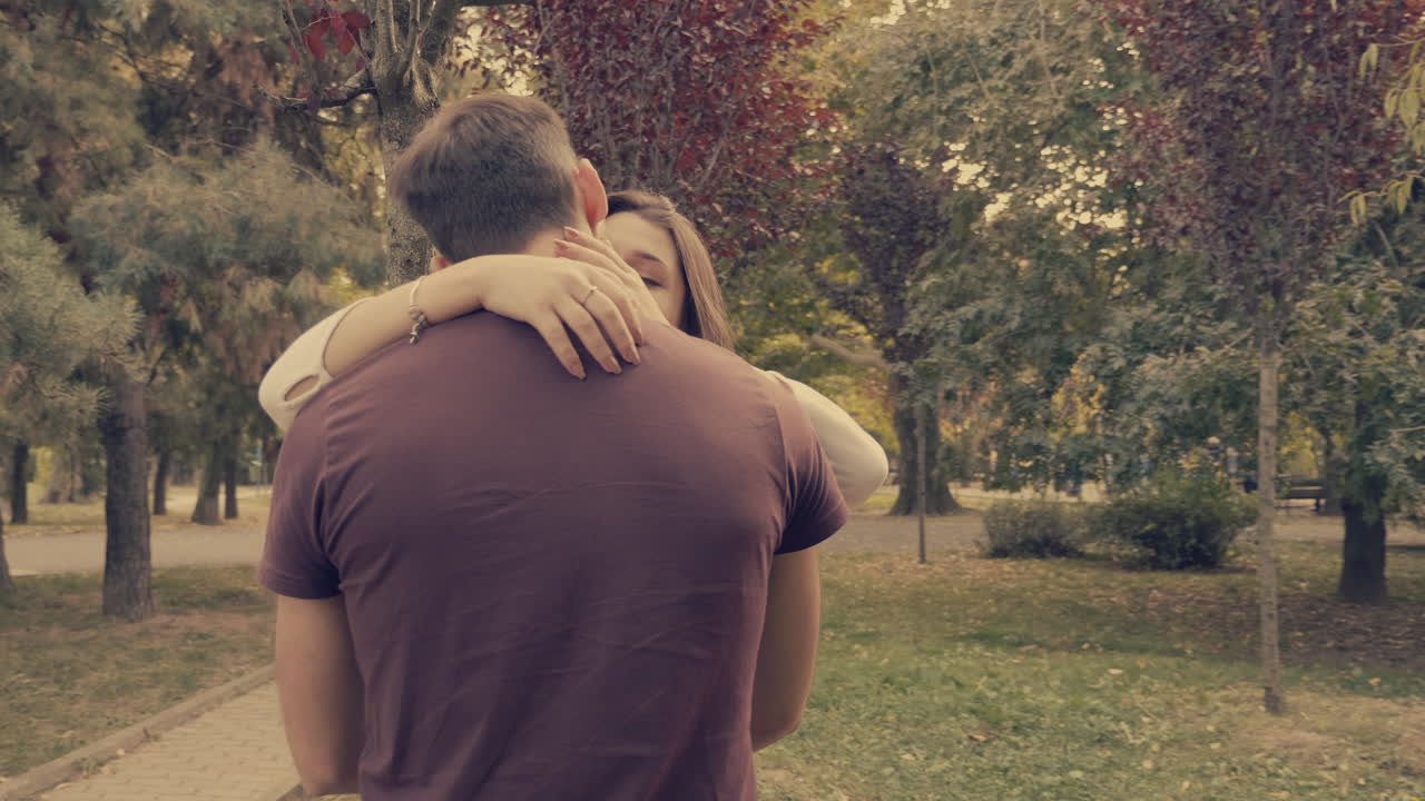 Romantic Couple Hugging and Kissing in a Park