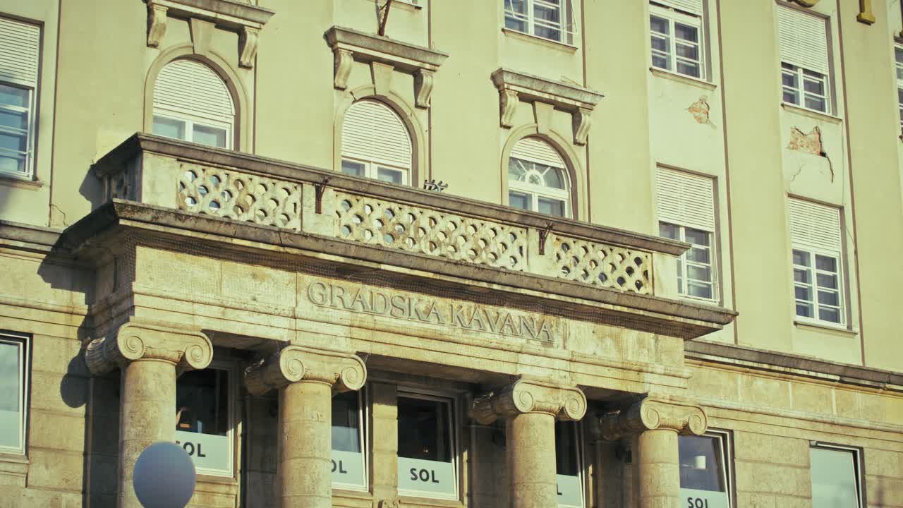 historic Gradska Kavana building façade in Zagreb, featuring columns and architectural details