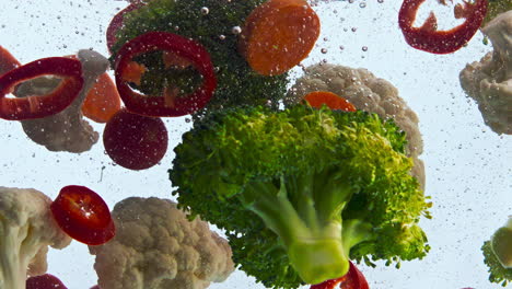 Tasty-veggies-dropped-water-on-white-background-close-up.-Organic-vegetables.