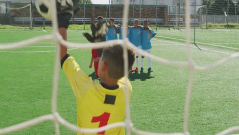 African-American-kid-in-red-scoring-in-a-sunny-day