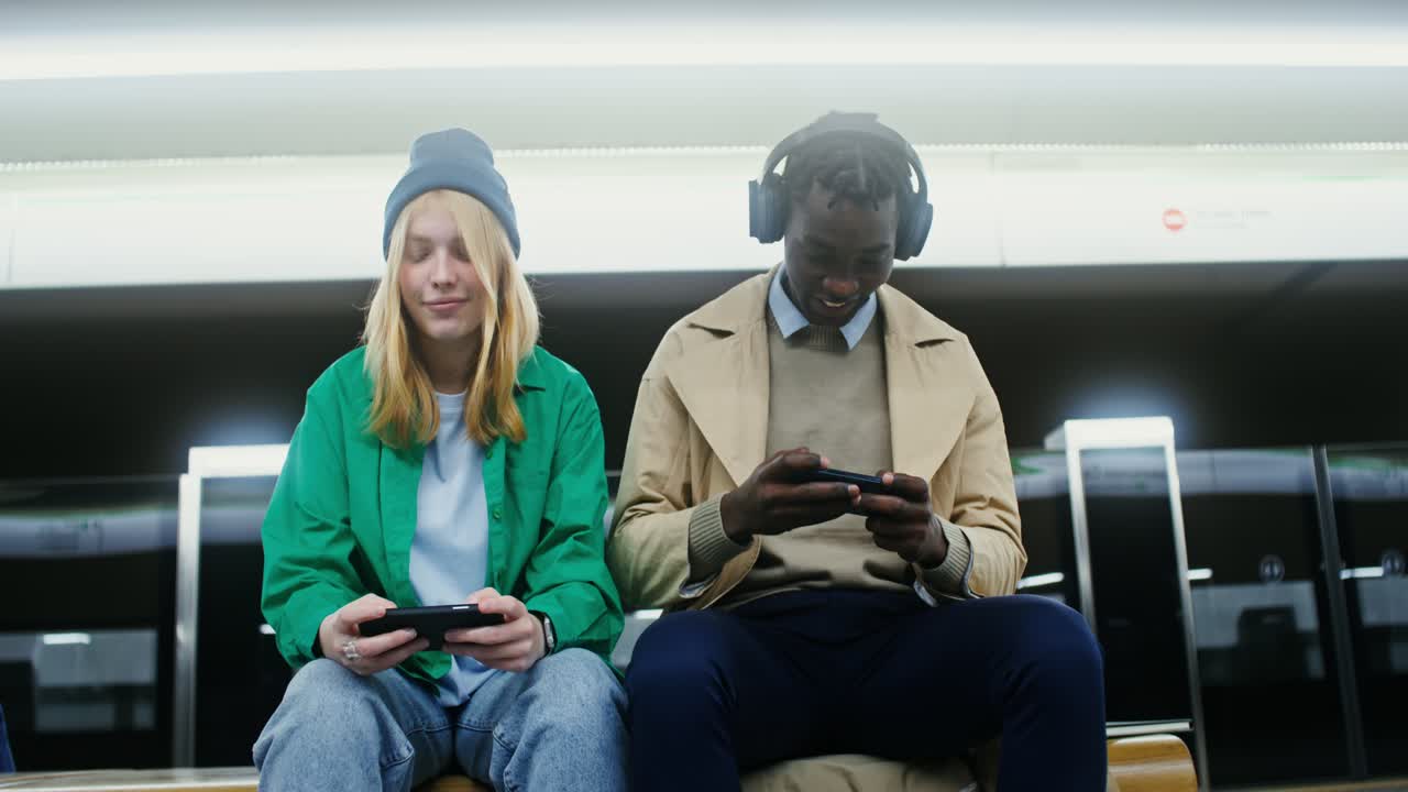 People playing games on their cellphones in the subway