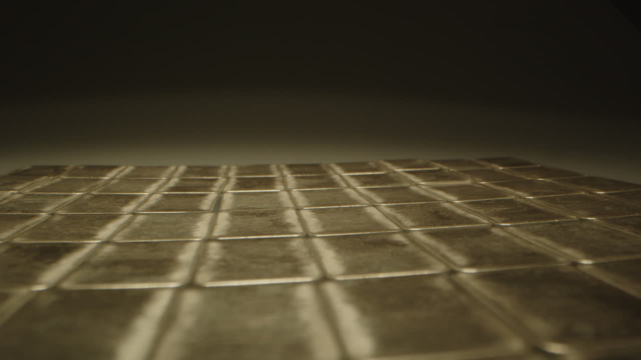 Cinematic dolly in of many silver bars in a dark room