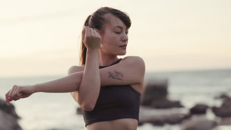 Woman-at-beach,-stretching-arms