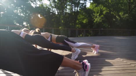 women doing plank exercise outdoors