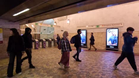 people walking through a metro station