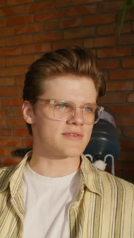 young man in striped shirt and glasses