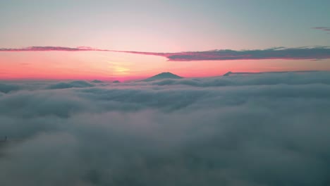 colorful sunset above grey cloudscape, aerial view