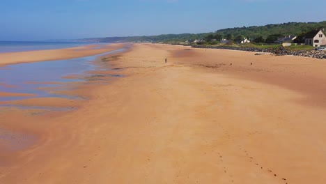 Good-aerial-over-dogs-running-on-Omaha-Beach-Normandy-France-site-of-World-War-two-D-Day-allied-invasion