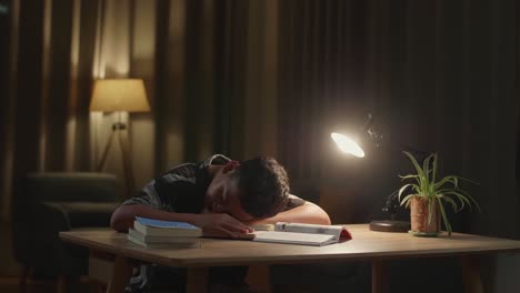 child sleeping while doing homework at night