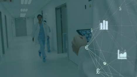 doctor walking in hospital corridor with financial data animation overlay
