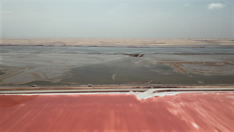 aerial view of a pink salt lake in a desert landscape