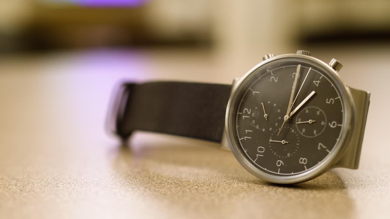 Wrist watch on a table with a blurry background