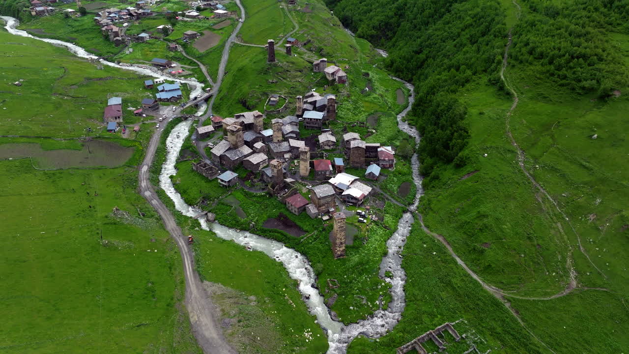 Enguri River Through Houses Village Of Ushguli - UNESCO Heritage Site In Svaneti, Georgia. Aerial Drone Shot