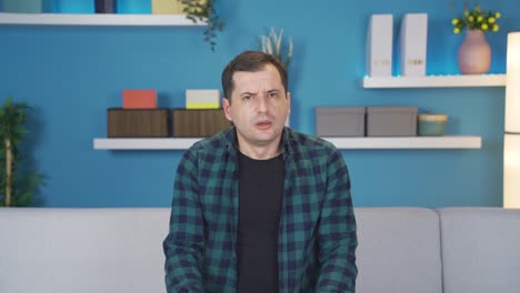 frightened and panicked man startled at home, seeing bad and creepy things.