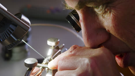 close-up of horologist using a machine