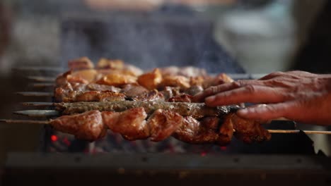 close-up of meat skewers grilling on a barbecue