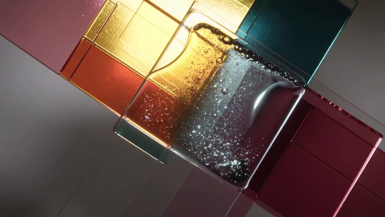 Releasing viscous amber liquid spreading across translucent tiles on studio table with bubbles