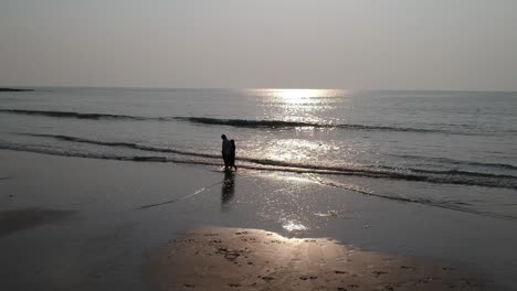 Couple-walking-at-beach---Aerial-drone-video