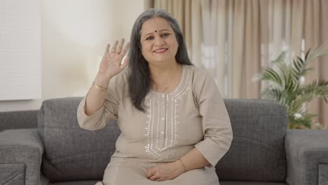 Happy-Indian-old-woman-waving-and-saying-Hello