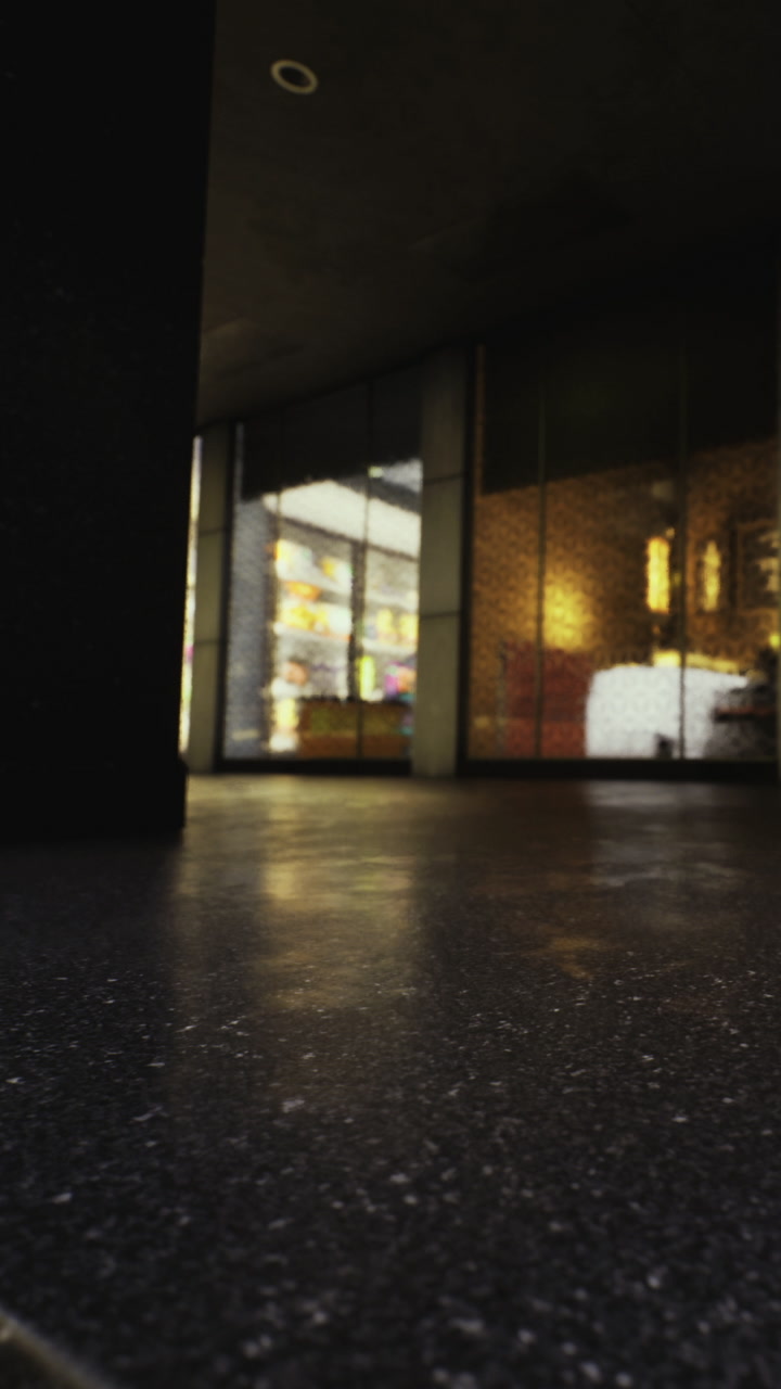 View of a modern building entrance with reflections and bright lights