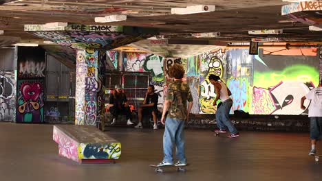 skateboarders performing tricks in urban skatepark