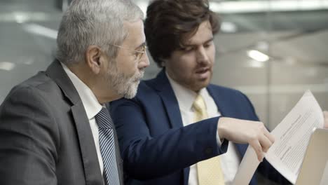 Young corporate employee pointing to contract