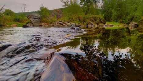 beautiful falling river in the forest clear water green tree cloudy