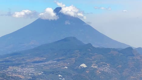 view of guatemala through plane window with volcano. aerial view of guatemala with volcano