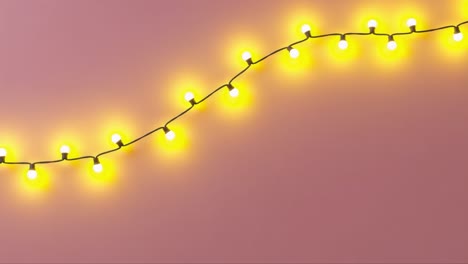 bright and warm string lights on a soft pink background, creating a cheerful atmosphere perfect for celebrations and cozy settings