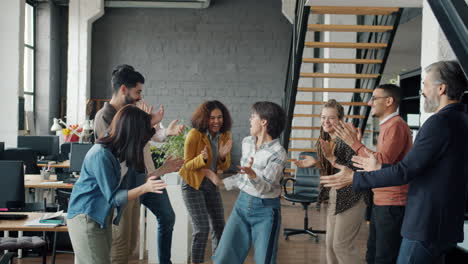 happy team celebrating success in office