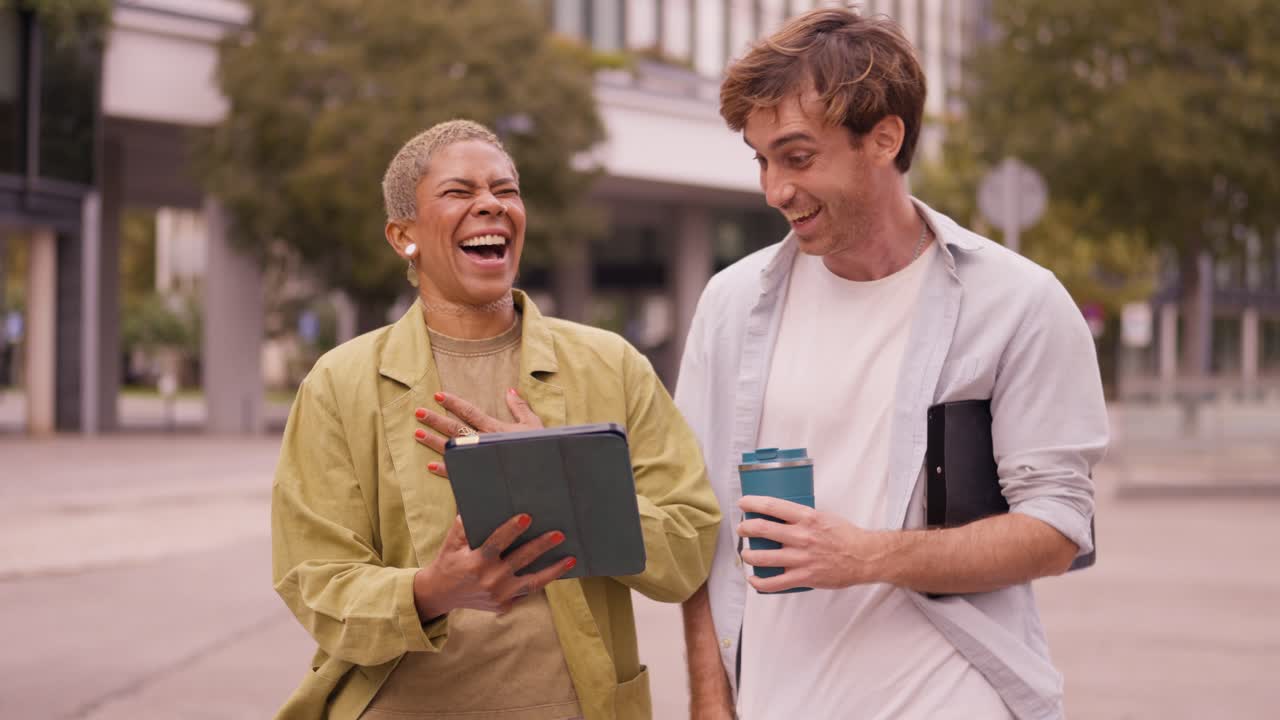 Business people discussing work on a tablet outdoors