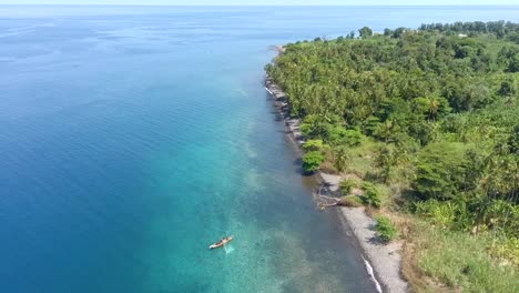 aerial fly back over fisherman boat on blue water, são tomé island