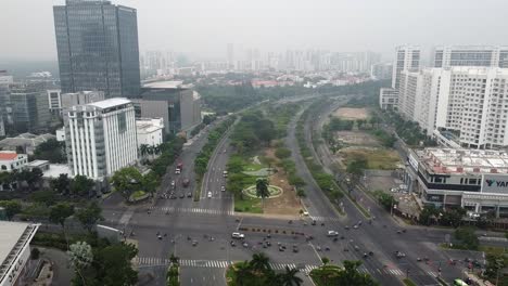 Static-drone-aerial-view-of-busy-intersection-road-crossing-in-district-7-vietnam