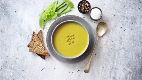 Green-pea-cream-soup-in-grey-bowl