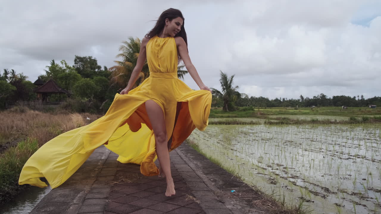 Woman in Yellow Dress Walking in Bali Rice Paddies