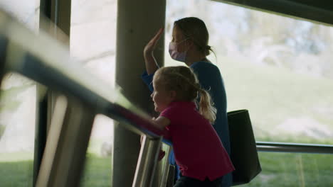 Mum-with-child-exploring-animal-world-in-the-zoo