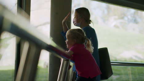 mum with child exploring animal world in the zoo